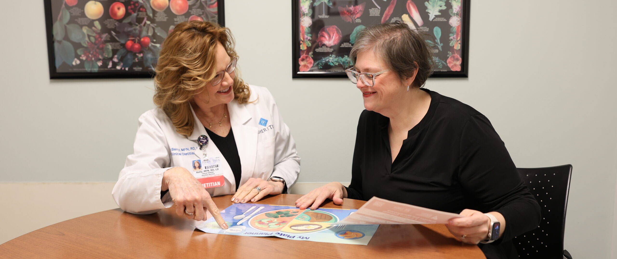Registered Dietitian Nutritionist Kelly Berry looks over a chart with Heather Smith, a diabetes education patient.